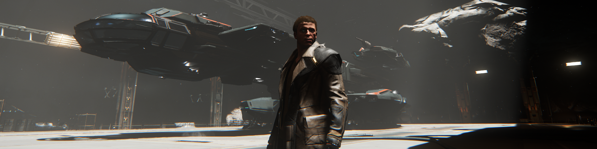 A man standing in front of a landed space cutter.